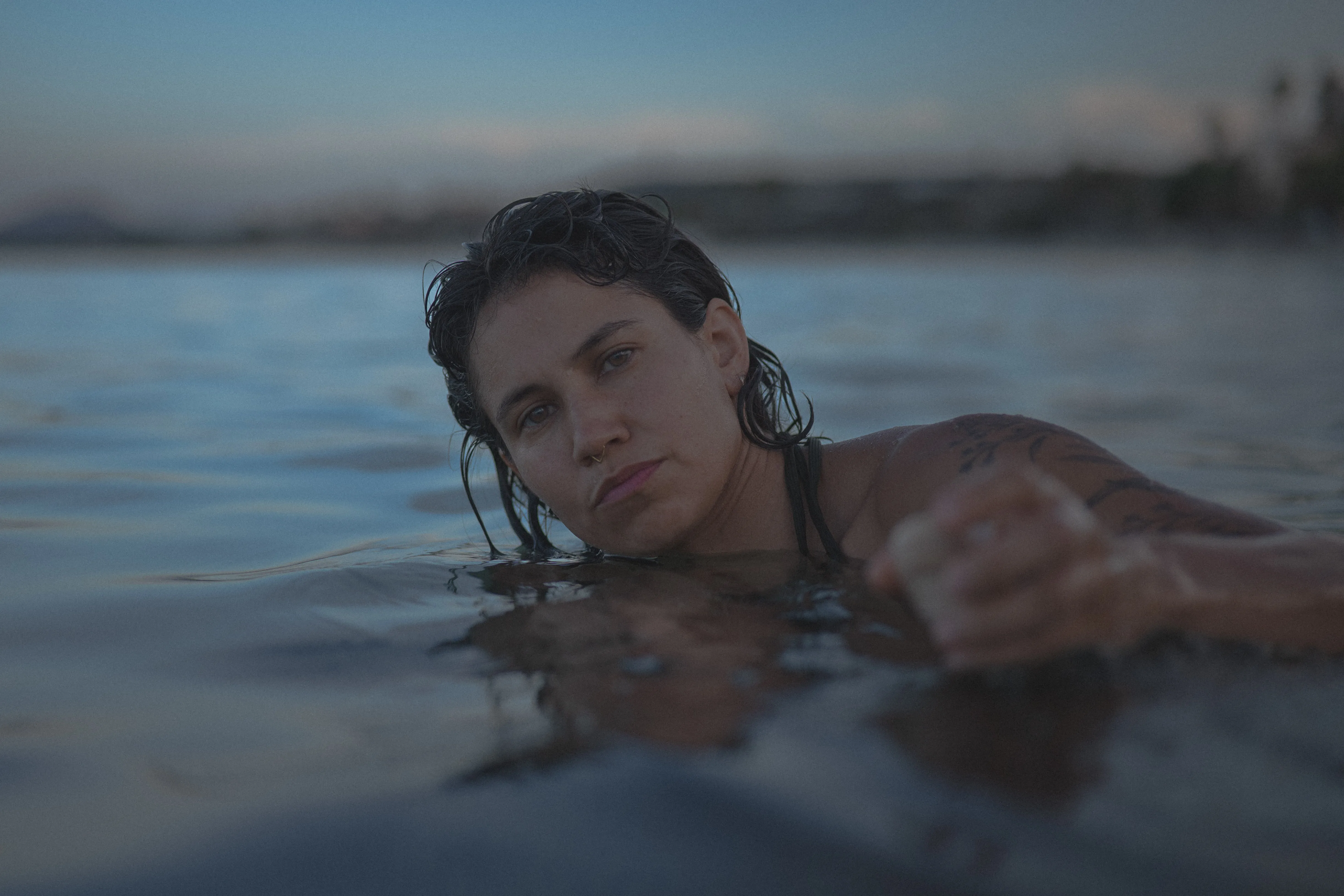 girl resting her head on a rock with shells on her face, playa la gaviota near los barriles, la paz, baja california sur, at blue hour (2)