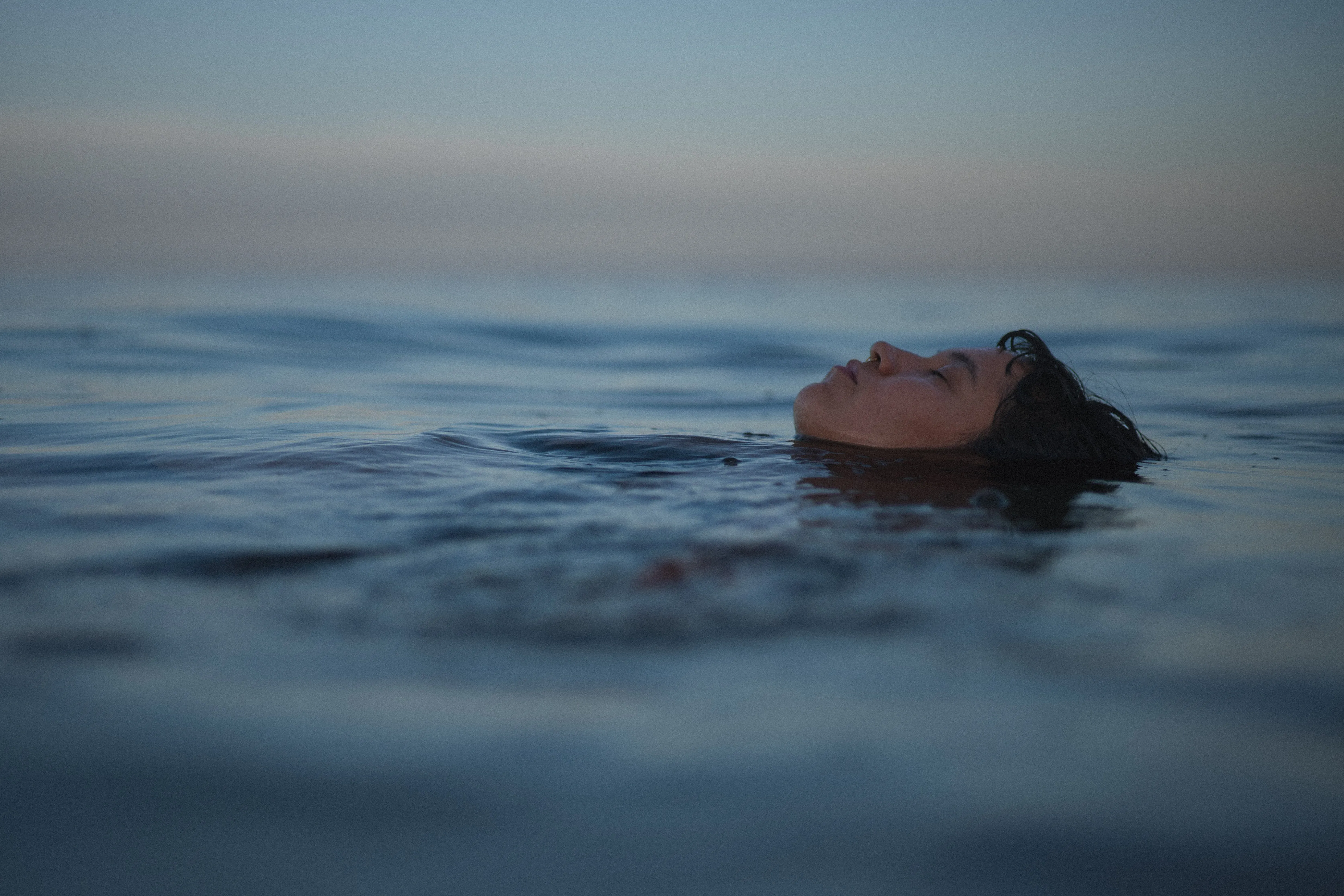 girl resting her head on a rock with shells on her face, playa la gaviota near los barriles, la paz, baja california sur, at blue hour (6)