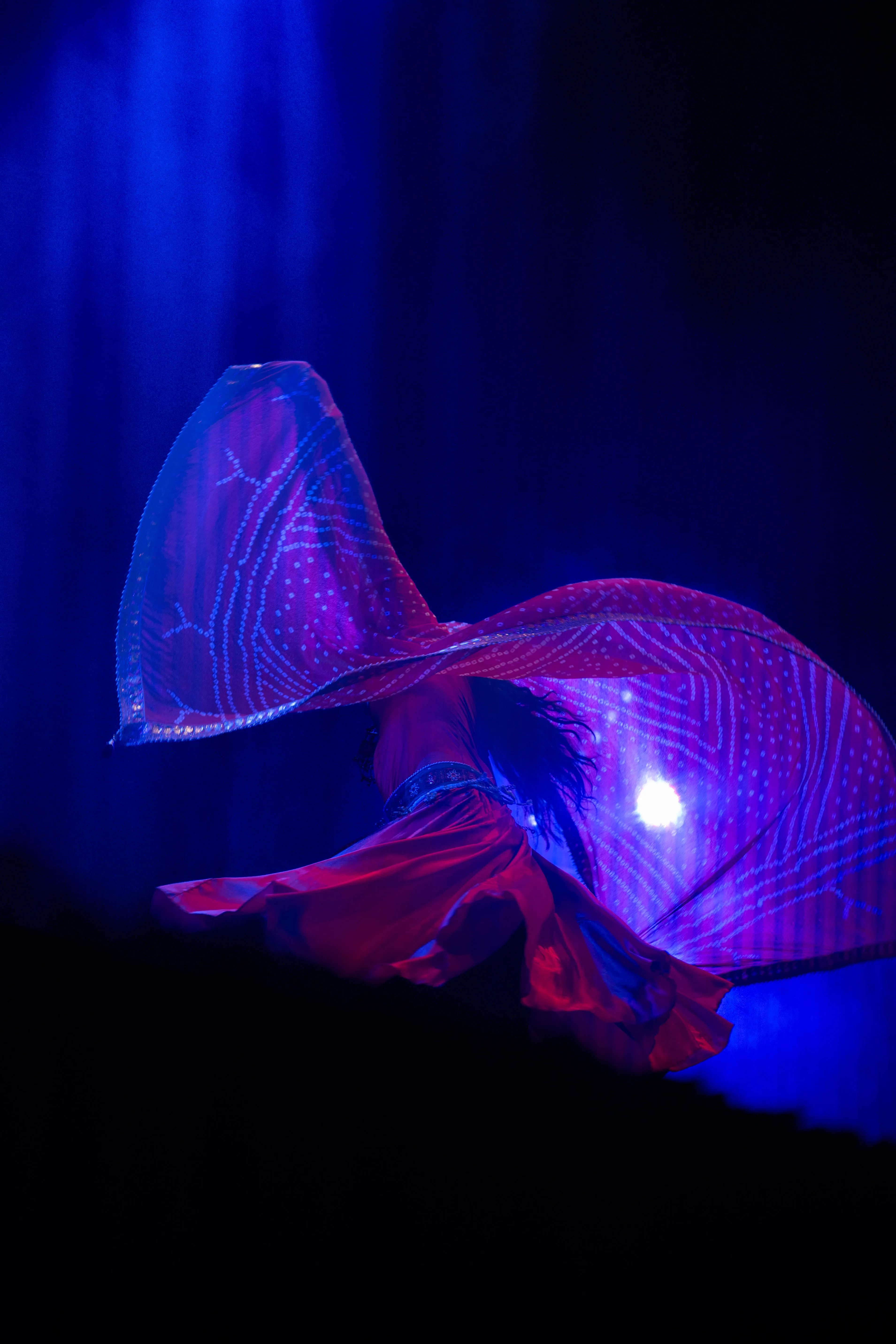 claudia llanos, rajasthani dancer from mexico, in a red dress under blue light and smoke, mexico city (cdmx) (4)