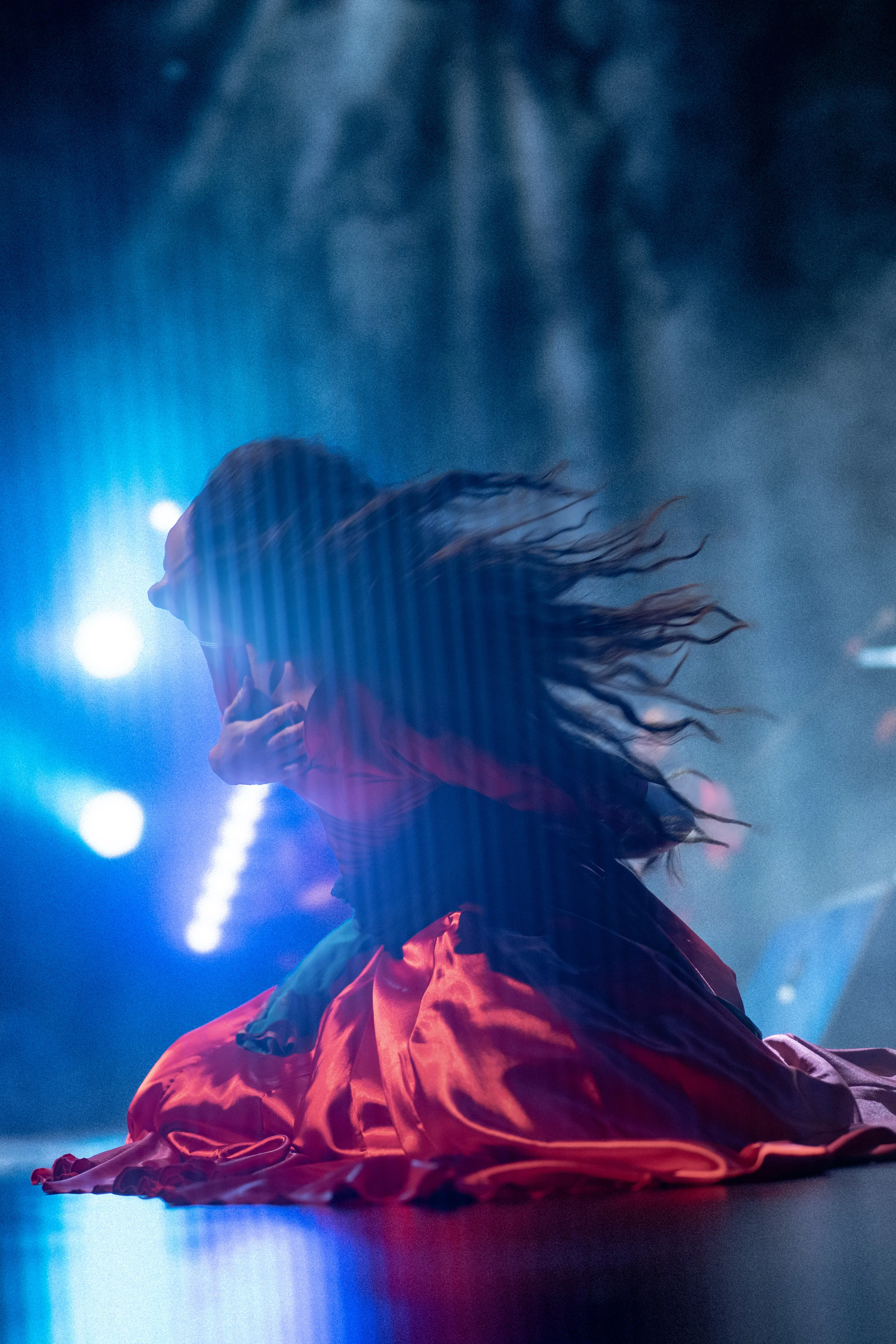 claudia llanos, rajasthani dancer from mexico, in a red dress under blue light and smoke, mexico city (cdmx) (5)