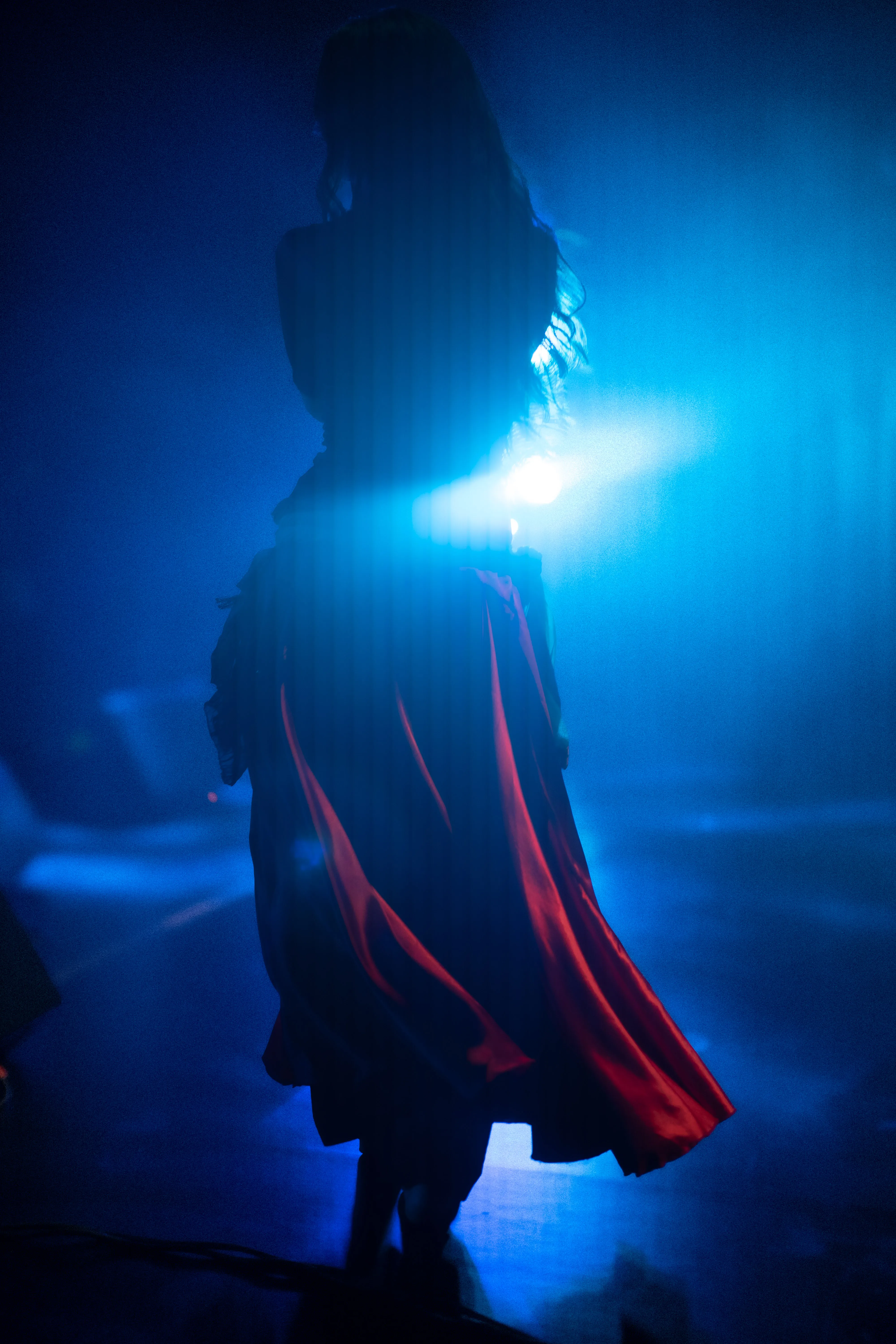 claudia llanos, rajasthani dancer from mexico, in a red dress under blue light and smoke, mexico city (cdmx) (6)